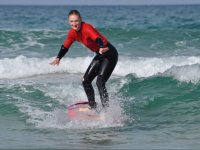  Surfing student standing on the board 