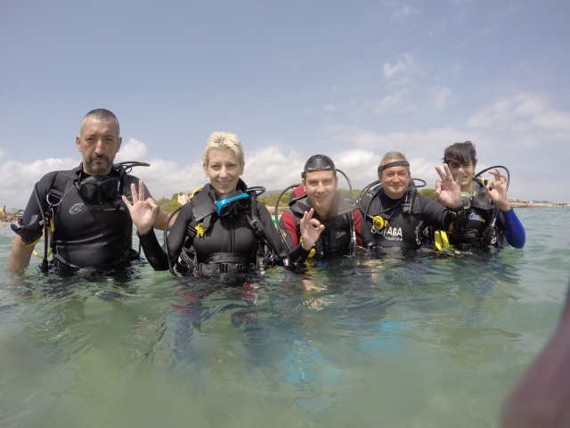  Divers submerged up to their waists 