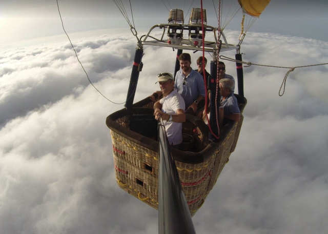  Passengers in a balloon above the clouds 