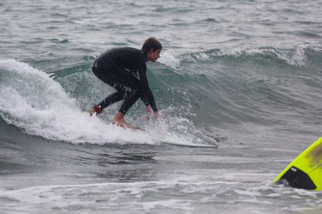 Crouching on the surfboard 