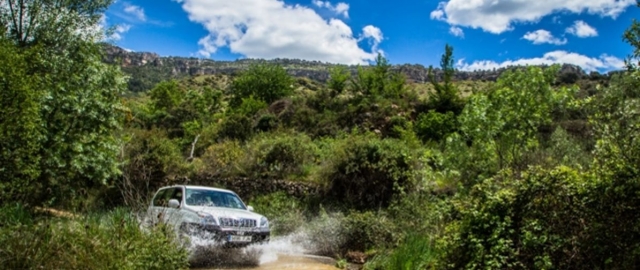  Geländewagen fährt durch eine Pfütze 