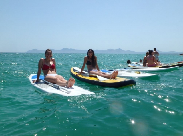  Girls sitting on sup boards 