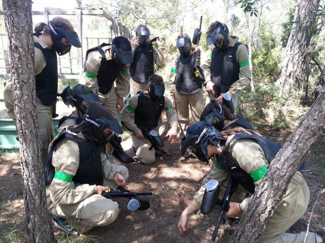  Paintball players looking at the ground 