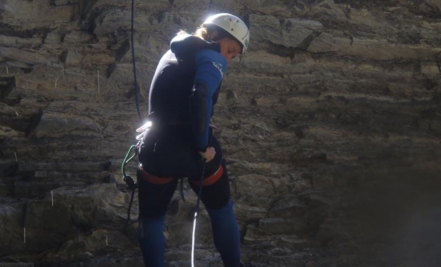  fille descendant une montagne avec des cordes 