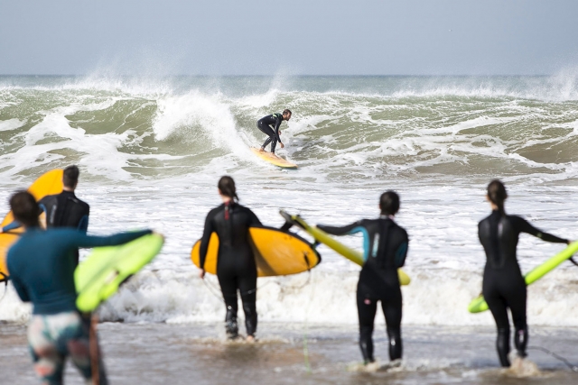 Alumnos surfeando frente a sus colegas