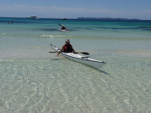 dos personas en kayak en la orilla del mar