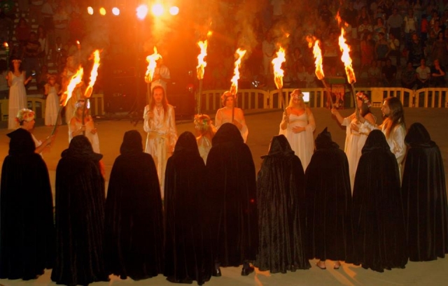 espectaculo de magia con personas vestidas de negro y otras de blanco