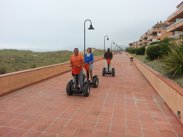 three people on a segway on a seafront promenade.jpg 