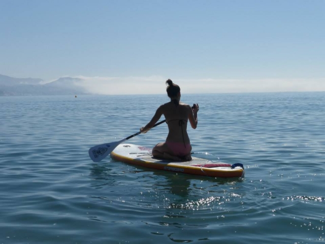  Sitting on the paddle surf board 