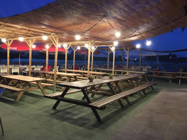  Tables in covered area at night 