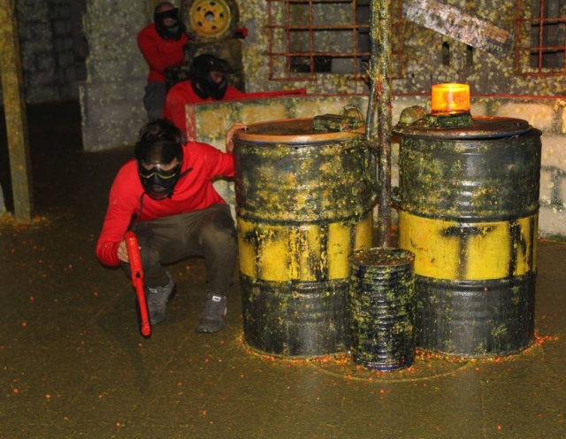  Paintball player holding onto the drum 