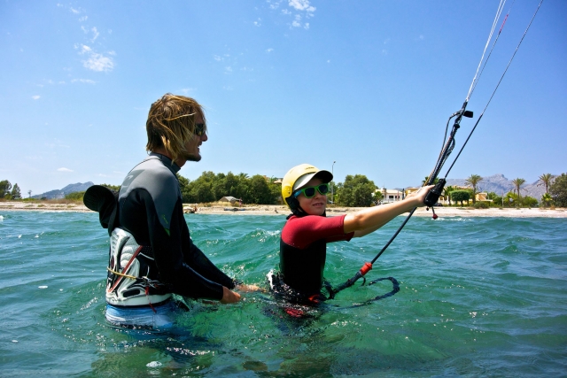  孩子在水中练习风筝冲浪 