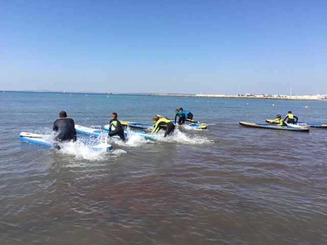Empujando las tablas de sup en el agua