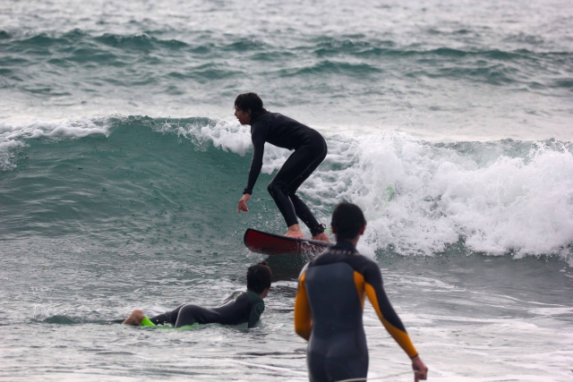  Standing reaching the shore with the board 