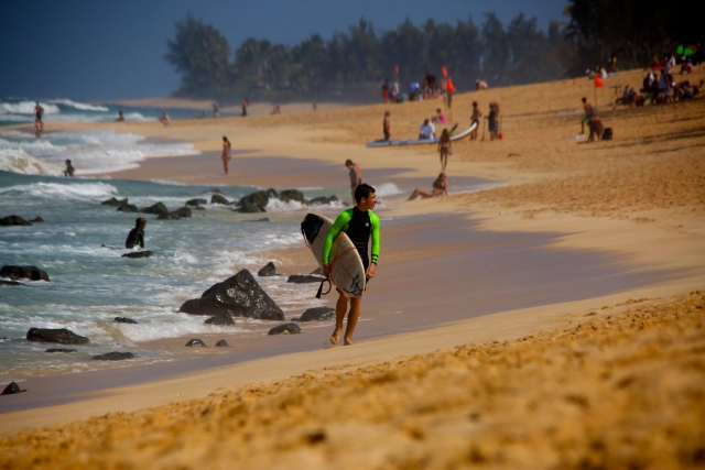  Surfer walking on the beach 