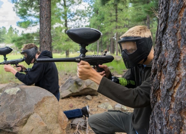  Paintball players between two trees 