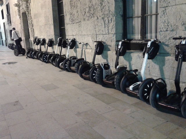  Segways leaning on the wall 