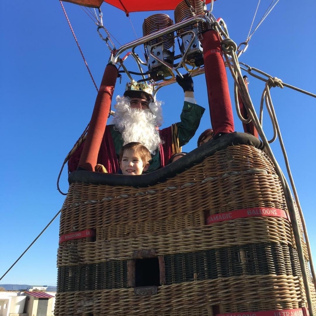 Rey mago con el peque en la cesta del globo