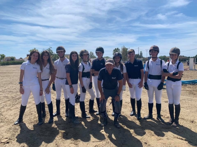 Foto de jinetes y profesor en la pista