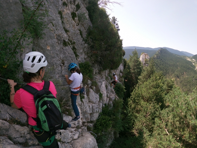 Jóvenes avanzando por la cuerda de la vía ferrata