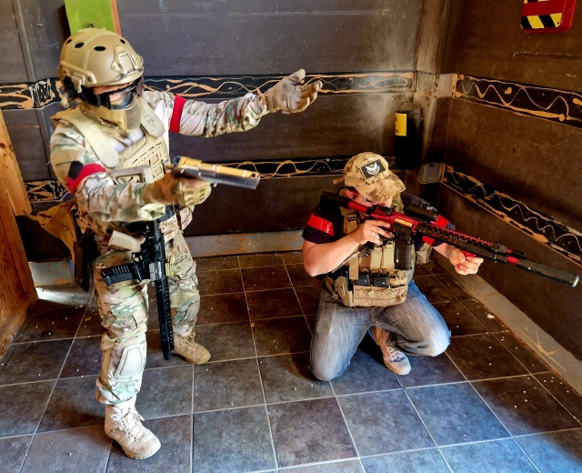  Two players, one crouching, the other standing, waiting for the order to take action 