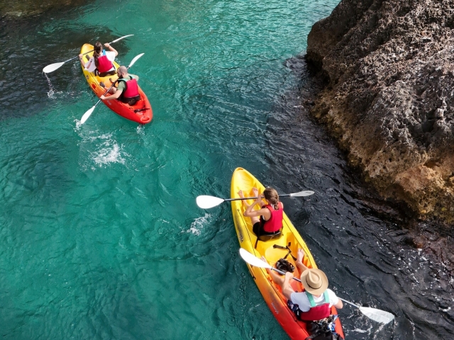 Kayaks skirting the rocks of the Costa del Sol 