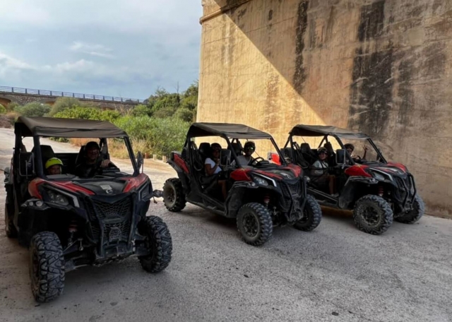  Three buggies parked below of a bridge