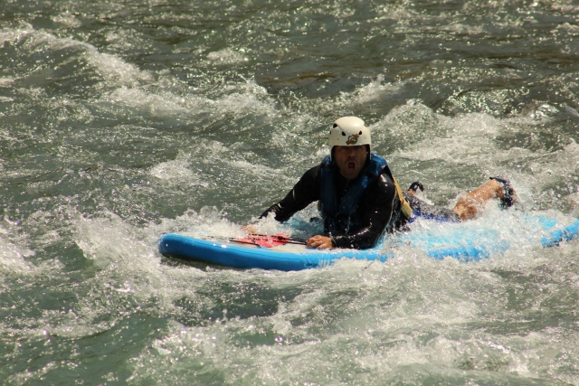  SUP lying in whitewater