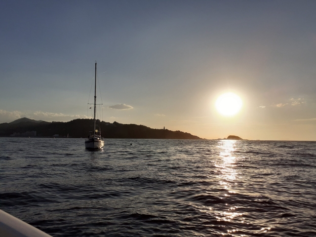  Le soleil est sur le point de se coucher sur les eaux calmes de la côte 