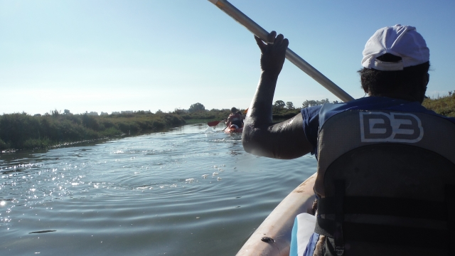  With the paddle in the kayak 