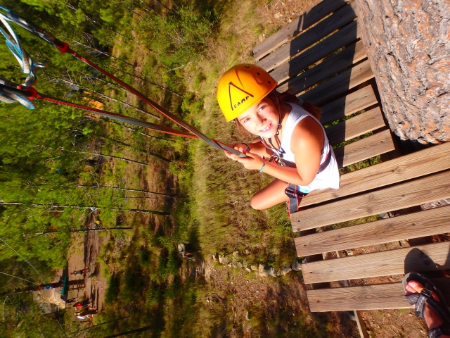  girl sitting on one of the zip line bases