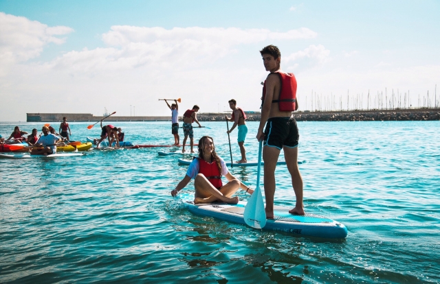 Colegio practicando paddle board