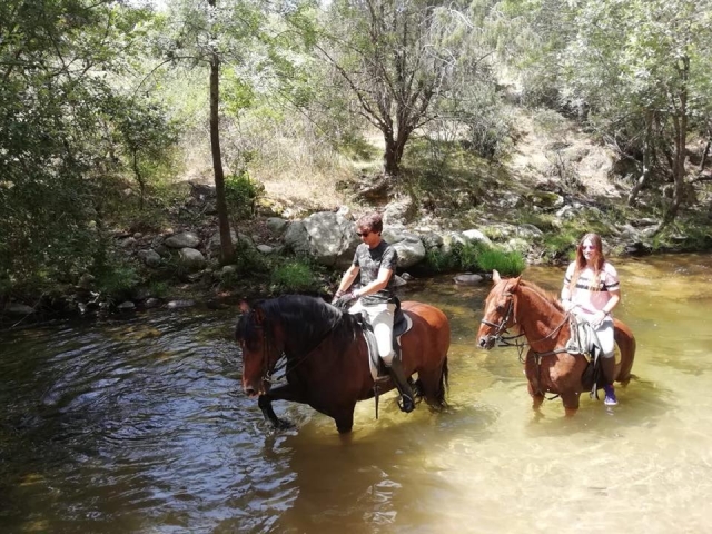  On horseback on the river bank 