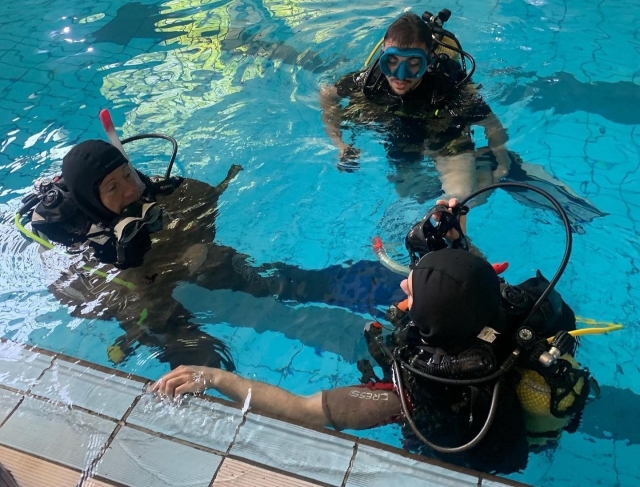 Junto al instructor en la piscina previo a la inmersión