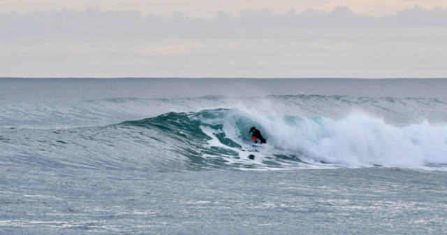 Surfer bajo la ola