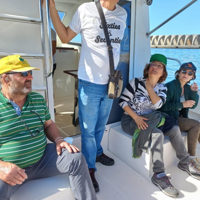  A group of older people sitting on the cover