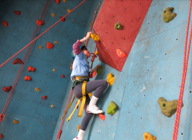 Nina escalando en rocódromo