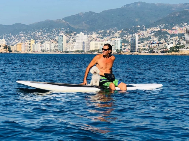 Sentado en la tabla de SUP en Acapulco