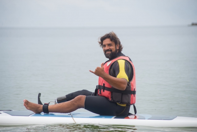 sentado sobre tabla de paddle surf