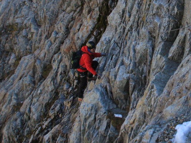  Mann beim Vorankommen am Klettersteig 