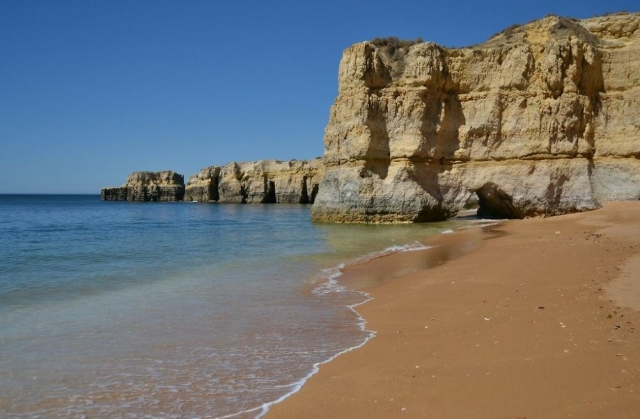  The beach seen from the shore with the cliffs in the background 