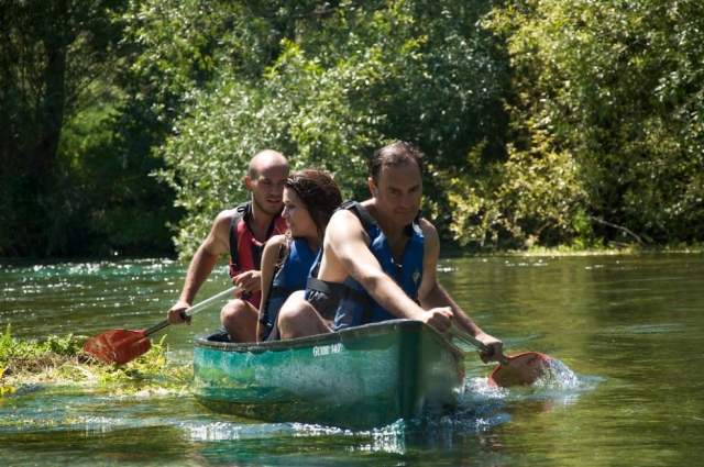  a canoe with three components sailing in the water