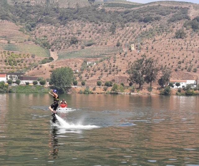  A user doing aerial juggling with the jet ski in the background 